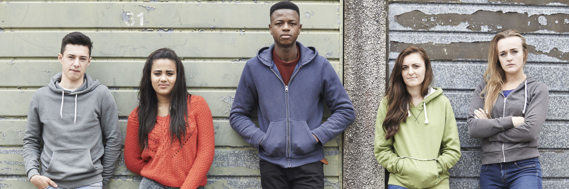 43050302 - gang of teenagers hanging out in urban environment